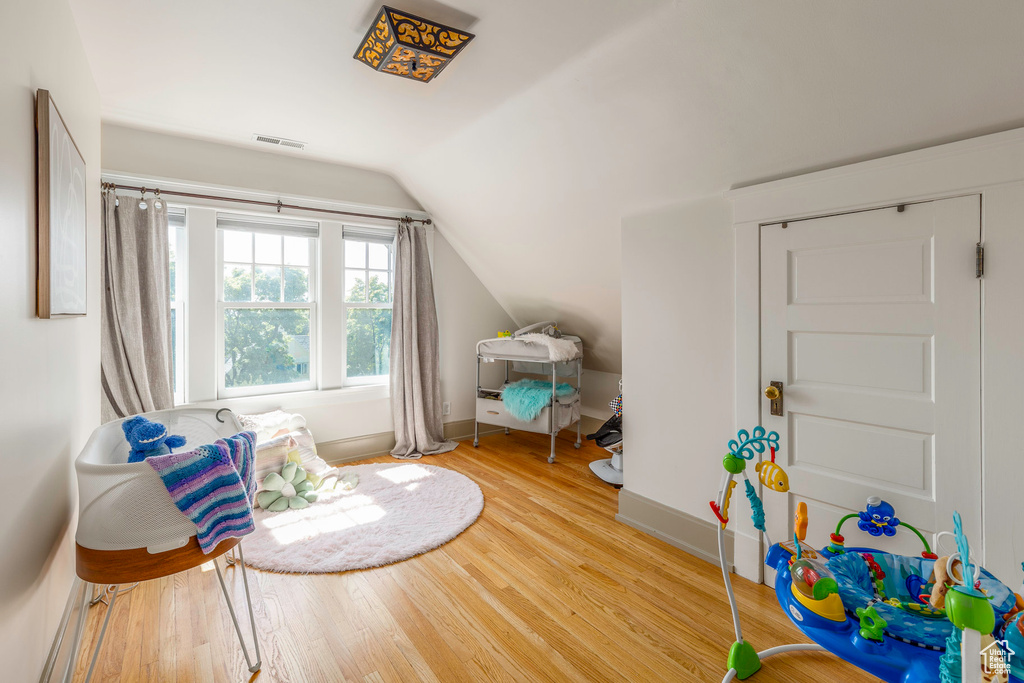 Bonus room with vaulted ceiling and wood-type flooring