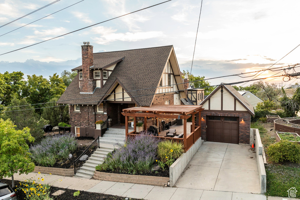 Tudor-style house featuring a garage