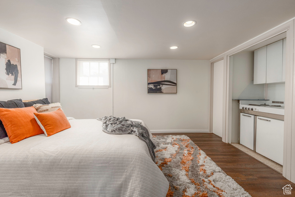 Bedroom with dark hardwood / wood-style flooring