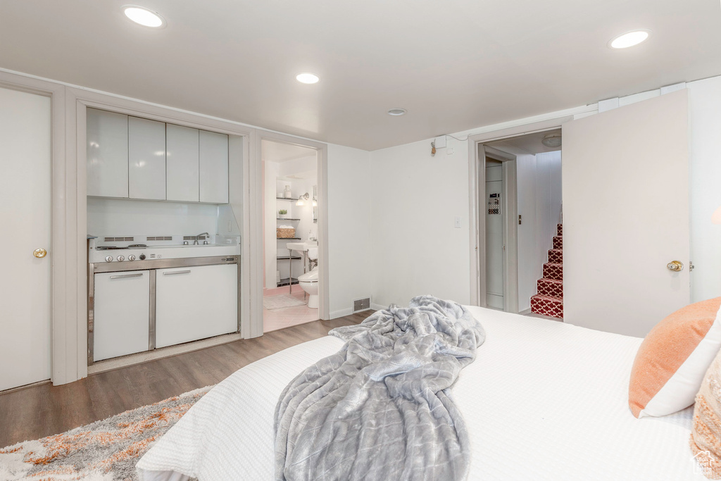 Bedroom featuring ensuite bathroom and light hardwood / wood-style floors