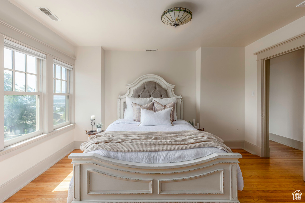 Bedroom featuring light hardwood / wood-style flooring and multiple windows