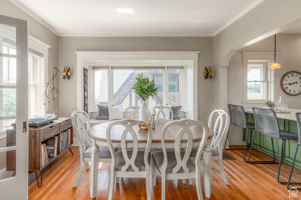 Dining space featuring hardwood / wood-style flooring and ornamental molding