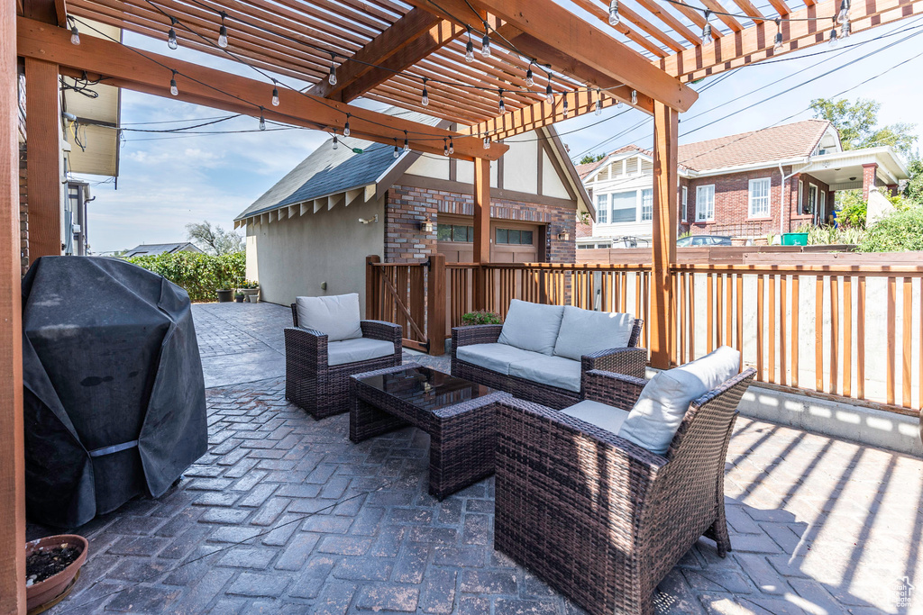 View of patio featuring outdoor lounge area, a grill, and a pergola