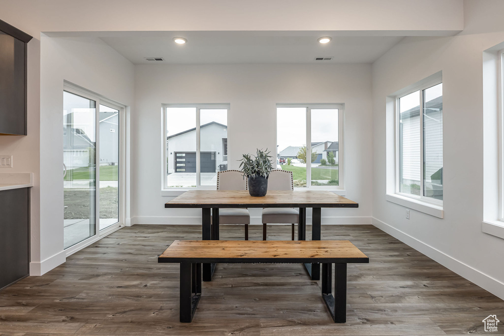 Dining space with a wealth of natural light, visible vents, and baseboards