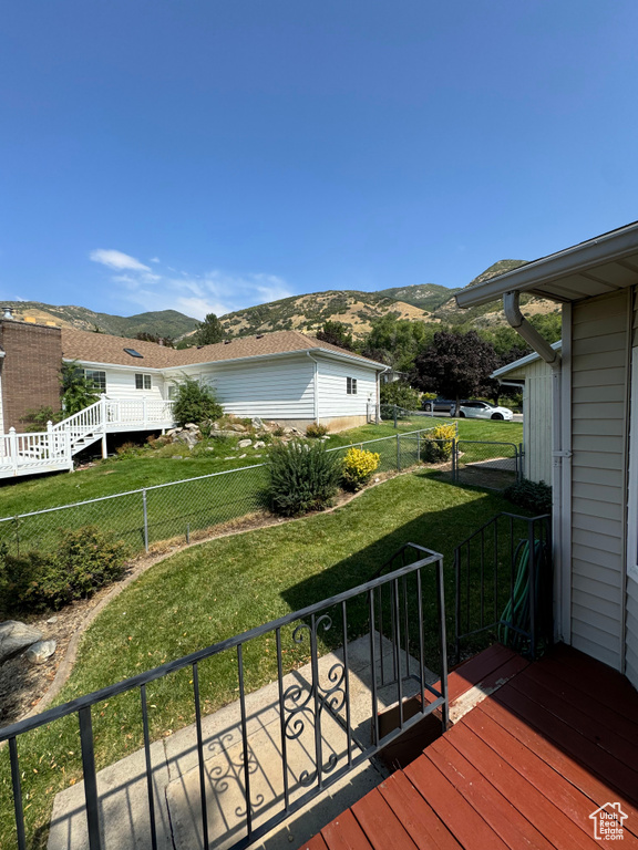 Wooden terrace with a mountain view and a yard