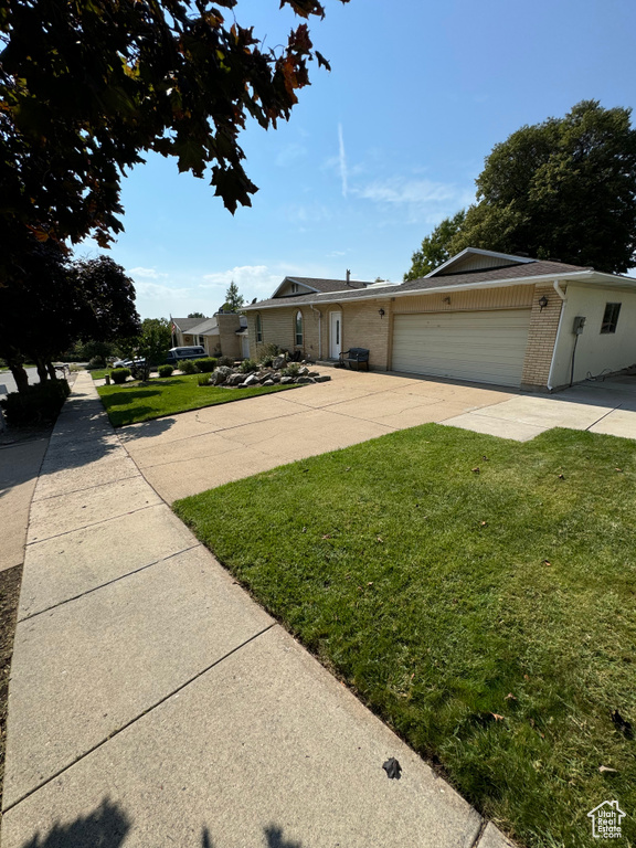 View of front of property with a garage and a front yard