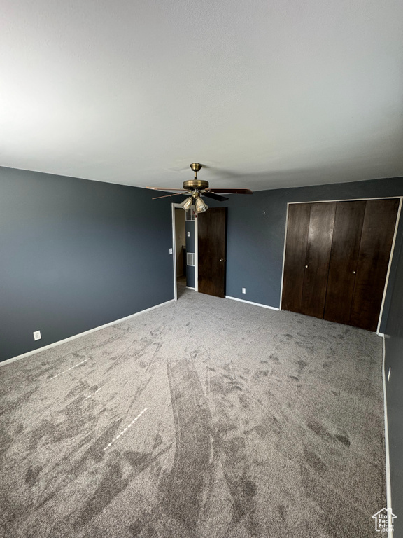 Interior space with ceiling fan and carpet