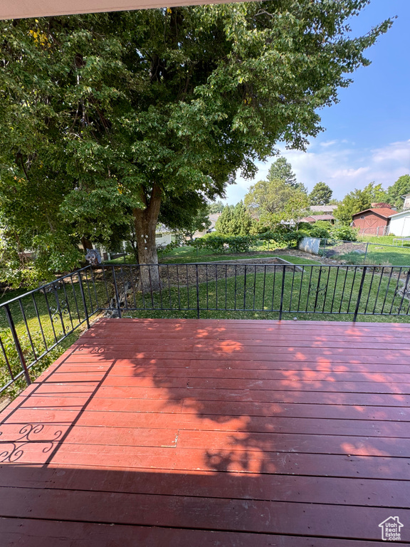 Wooden deck featuring a lawn