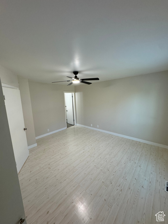 Spare room featuring ceiling fan and light wood-type flooring