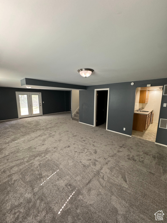 Unfurnished living room featuring light colored carpet