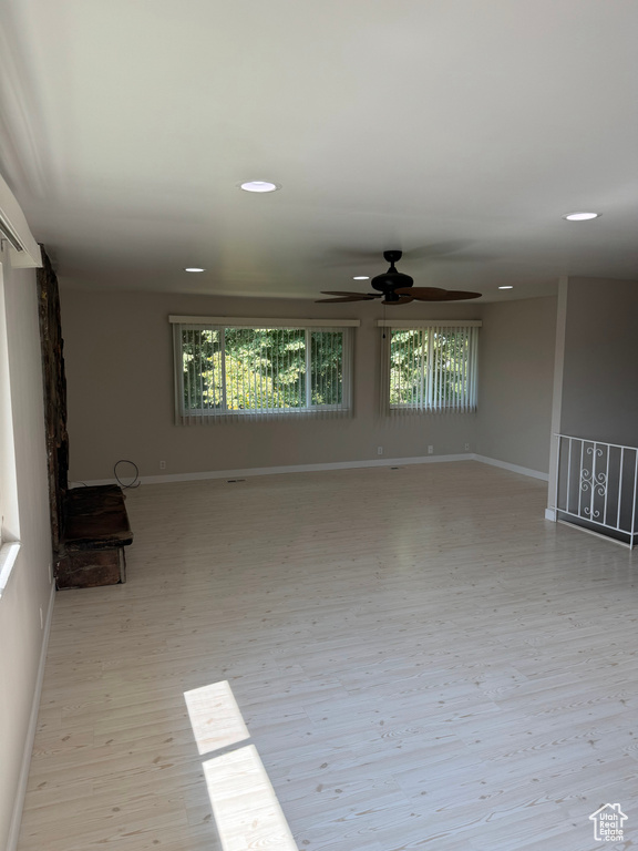 Unfurnished living room with a wealth of natural light and light wood-type flooring