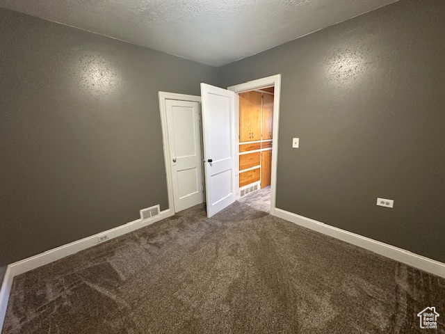 Unfurnished bedroom with a textured ceiling