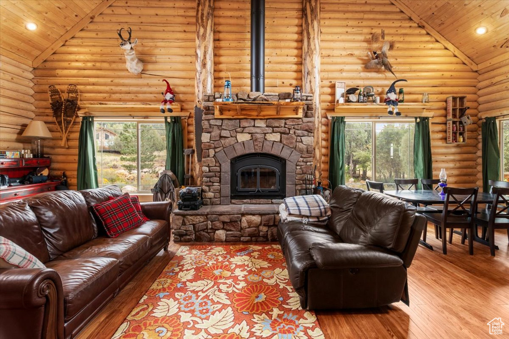 Living room with wood ceiling, log walls, and wood-type flooring