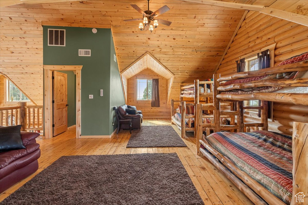 Bedroom with wood ceiling, light hardwood / wood-style flooring, and high vaulted ceiling