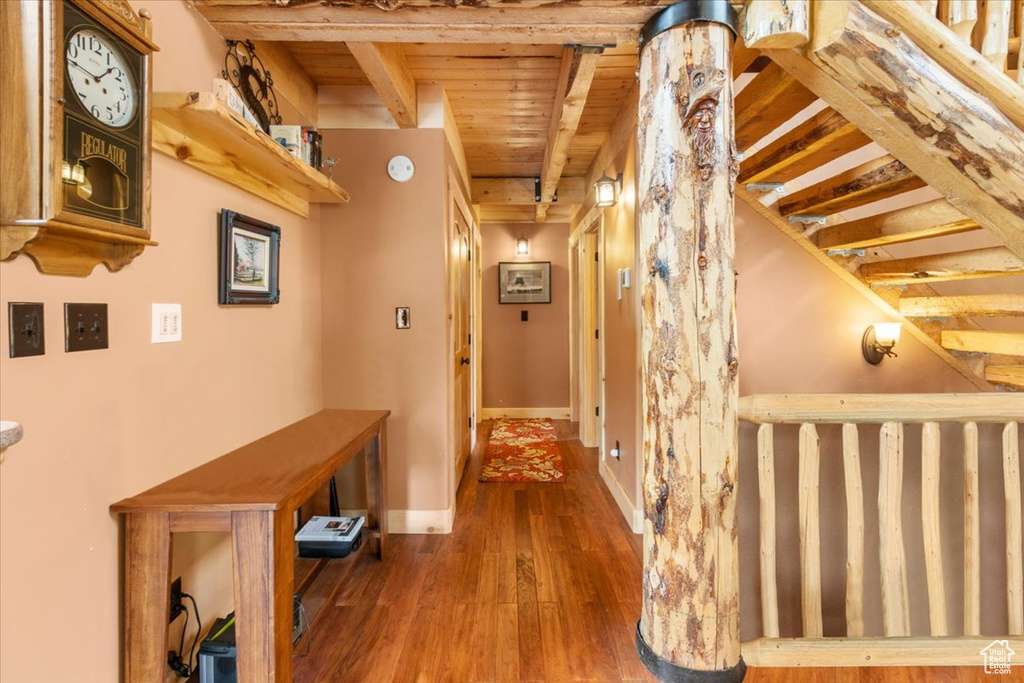 Hallway featuring wood ceiling, beam ceiling, and hardwood / wood-style flooring