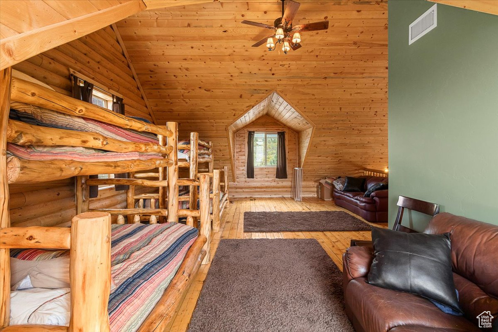 Bedroom with light wood-type flooring, wood ceiling, and high vaulted ceiling