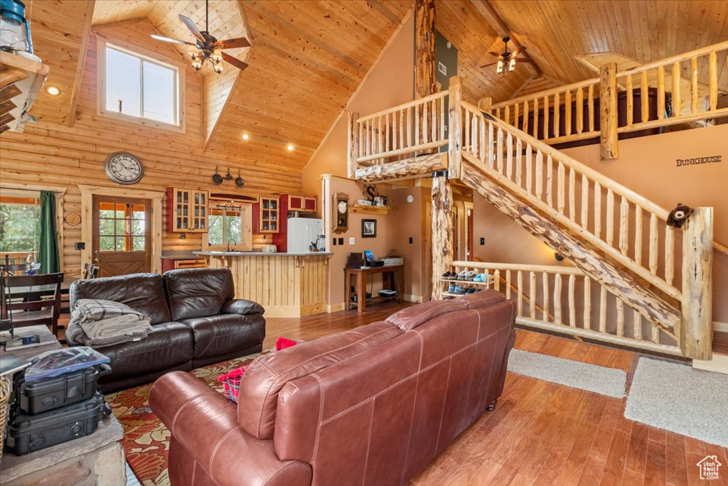 Living room featuring wood ceiling, ceiling fan, high vaulted ceiling, and hardwood / wood-style flooring