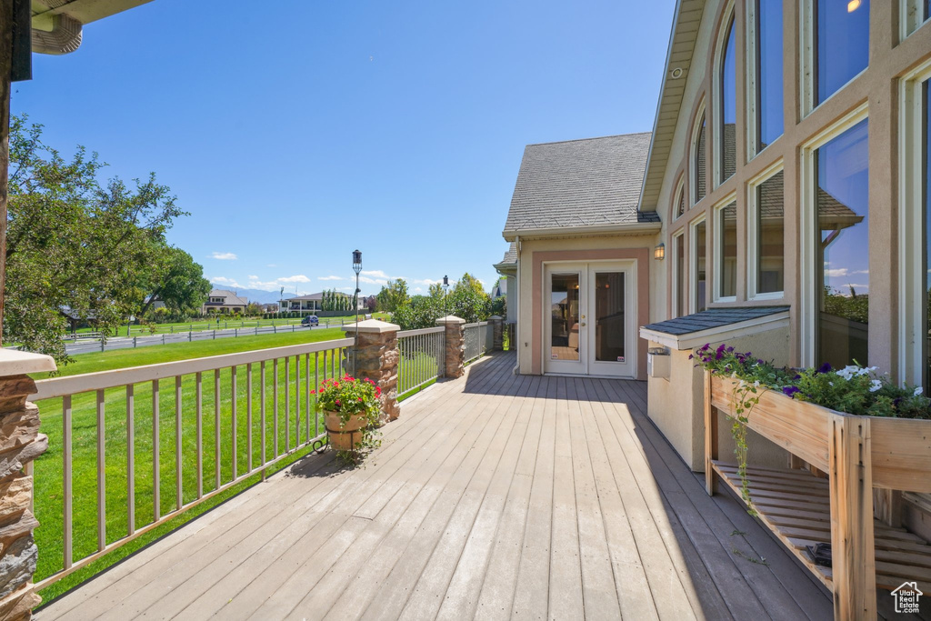 Deck featuring a yard and french doors