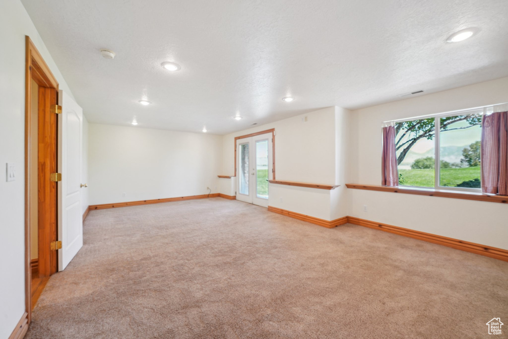 Spare room featuring a textured ceiling and carpet flooring