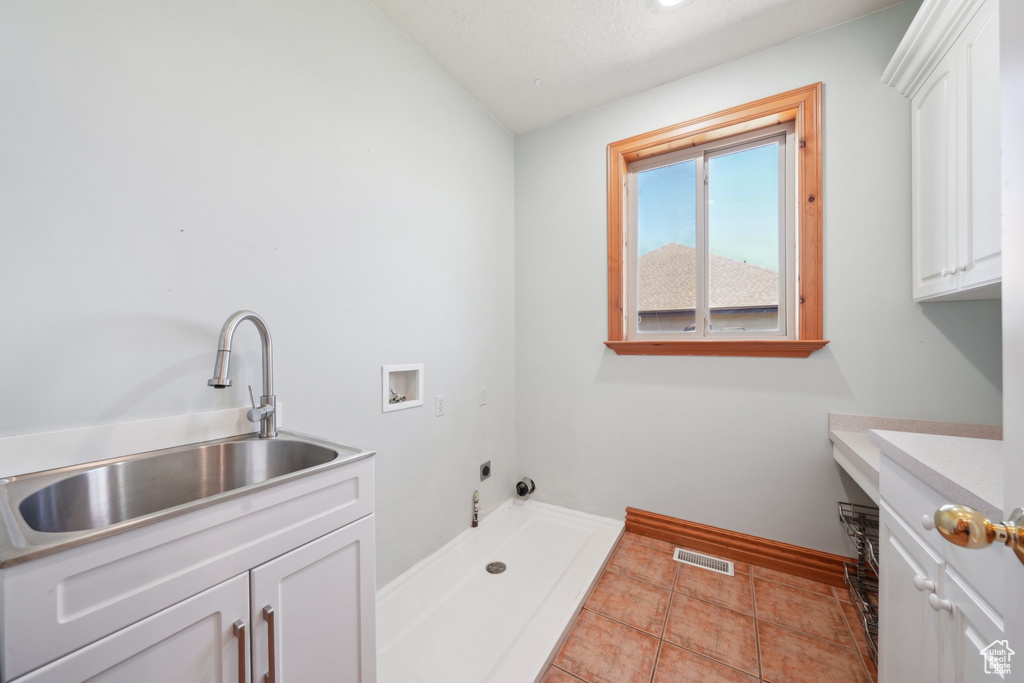 Bathroom featuring vanity, vaulted ceiling, walk in shower, and tile patterned flooring