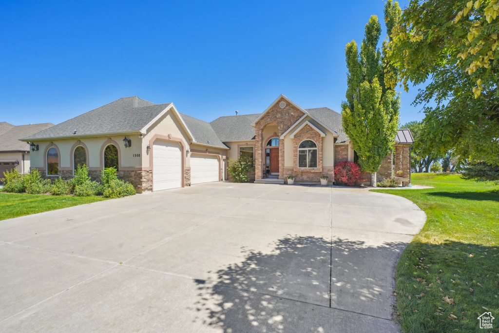 View of front of home featuring a garage and a front lawn