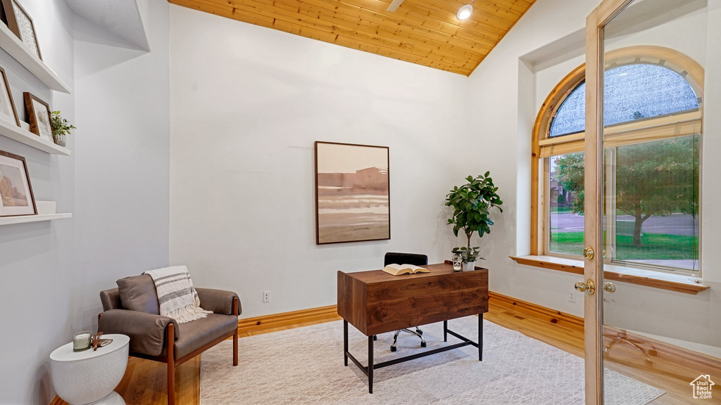 Home office with wood ceiling, high vaulted ceiling, and light hardwood / wood-style flooring