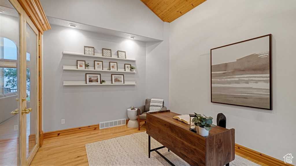 Office space featuring light wood-type flooring, vaulted ceiling, and wooden ceiling