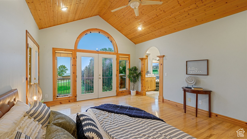 Bedroom with multiple windows, high vaulted ceiling, wooden ceiling, and light hardwood / wood-style flooring