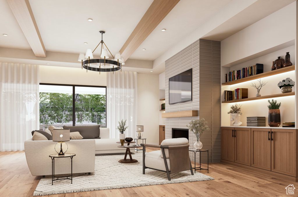 Living room with a chandelier, a brick fireplace, beam ceiling, and light hardwood / wood-style floors