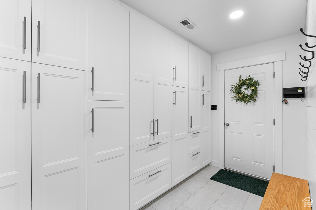 Foyer entrance featuring light tile patterned floors