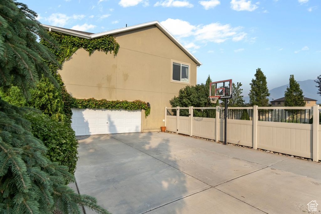 View of property exterior with a garage