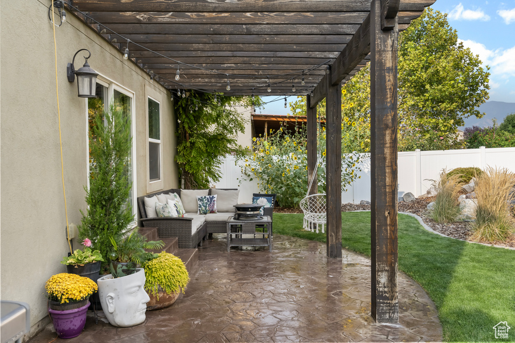 View of patio with an outdoor living space and a pergola