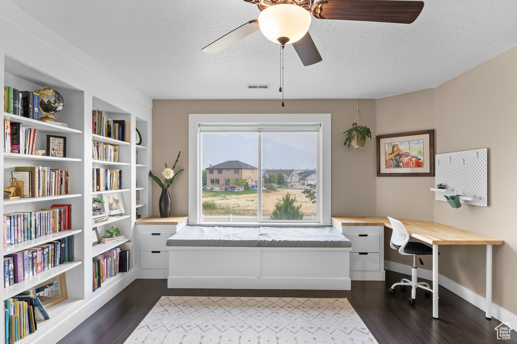 Office area with dark hardwood / wood-style flooring, ceiling fan, and a textured ceiling