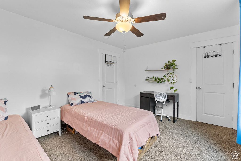 Bedroom featuring ceiling fan and carpet flooring