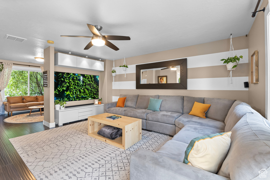 Living room with ceiling fan and light hardwood / wood-style floors