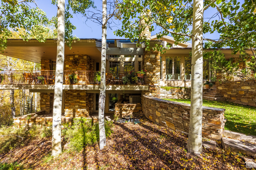 Back of property featuring stone siding