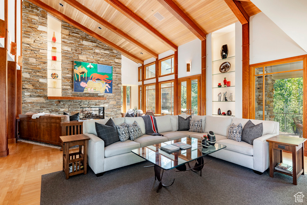 Living room featuring beamed ceiling, high vaulted ceiling, wooden ceiling, and wood finished floors