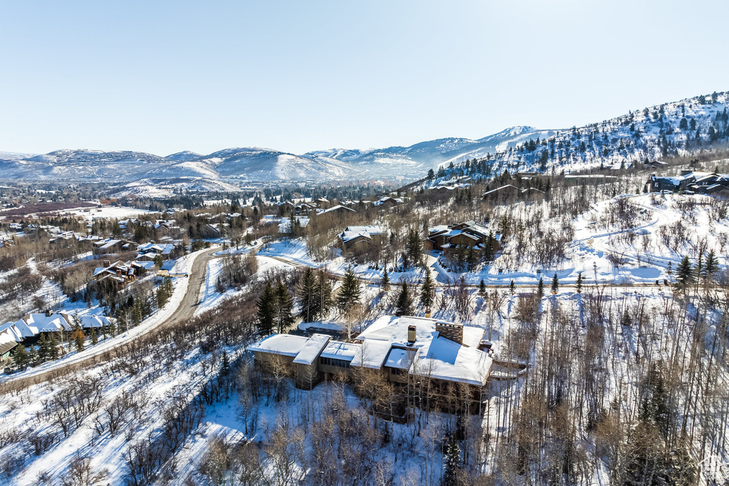 Snowy aerial view featuring a mountain view