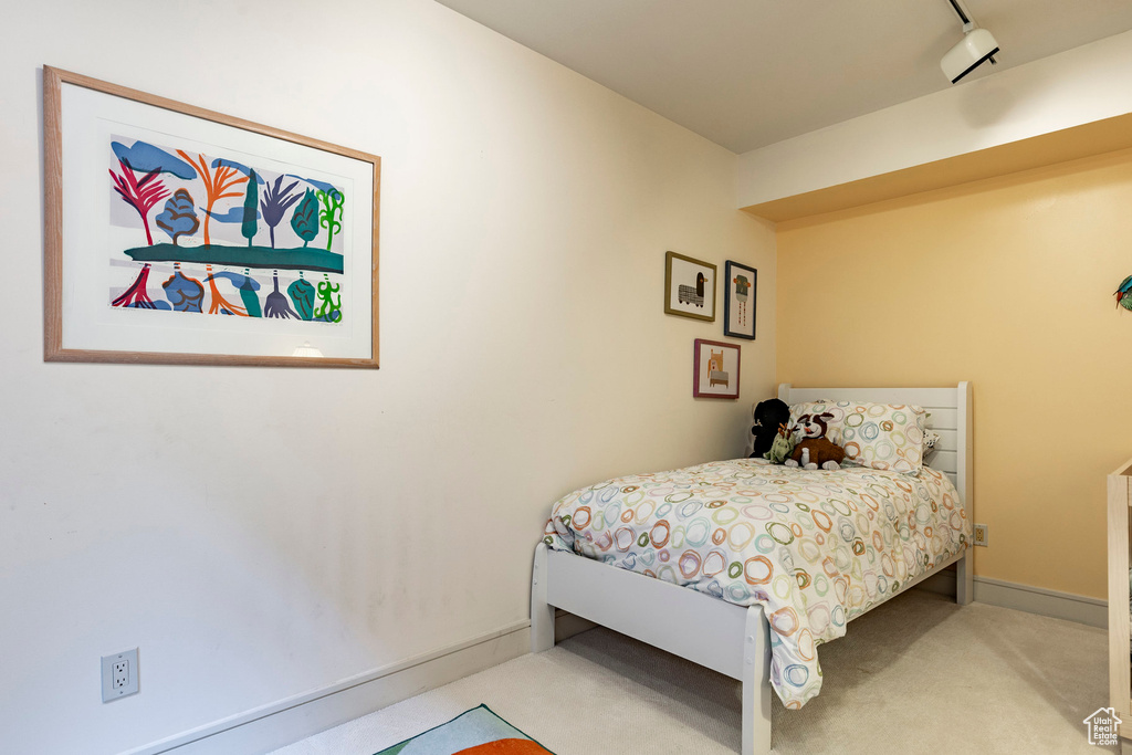 Bedroom with light colored carpet
