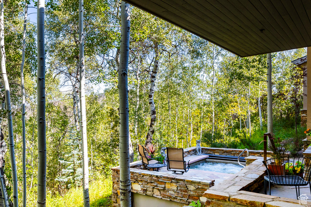 View of patio featuring a forest view
