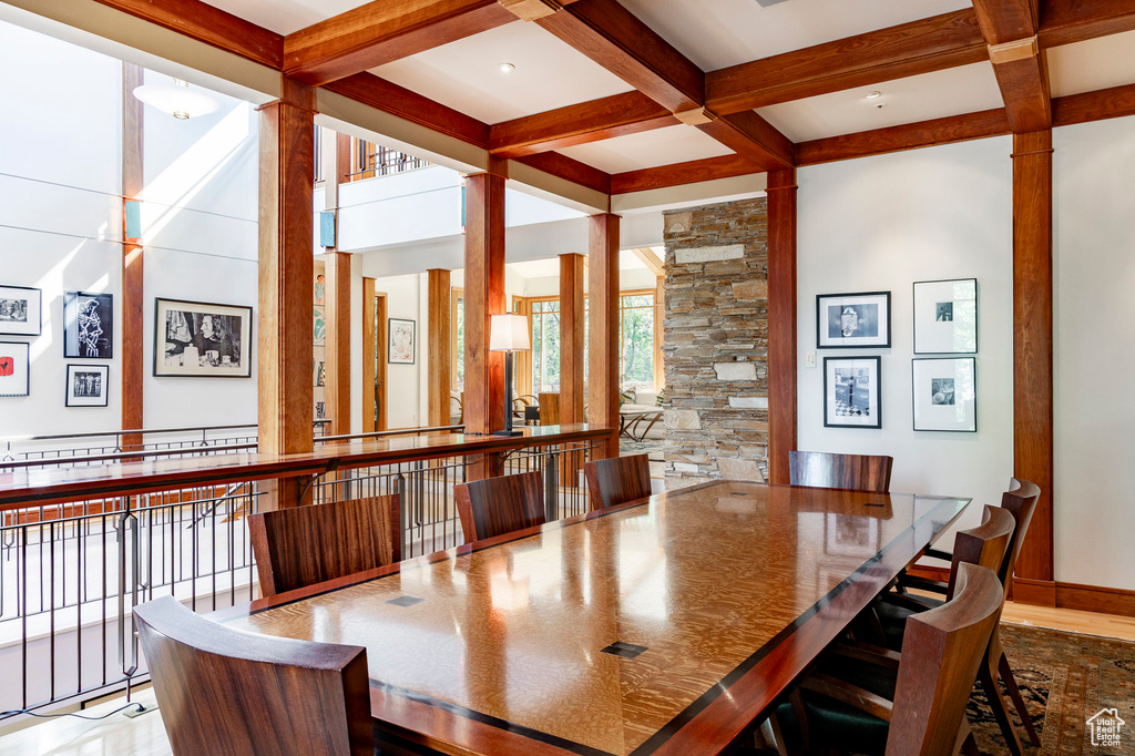 Dining space with beamed ceiling, coffered ceiling, and ornate columns