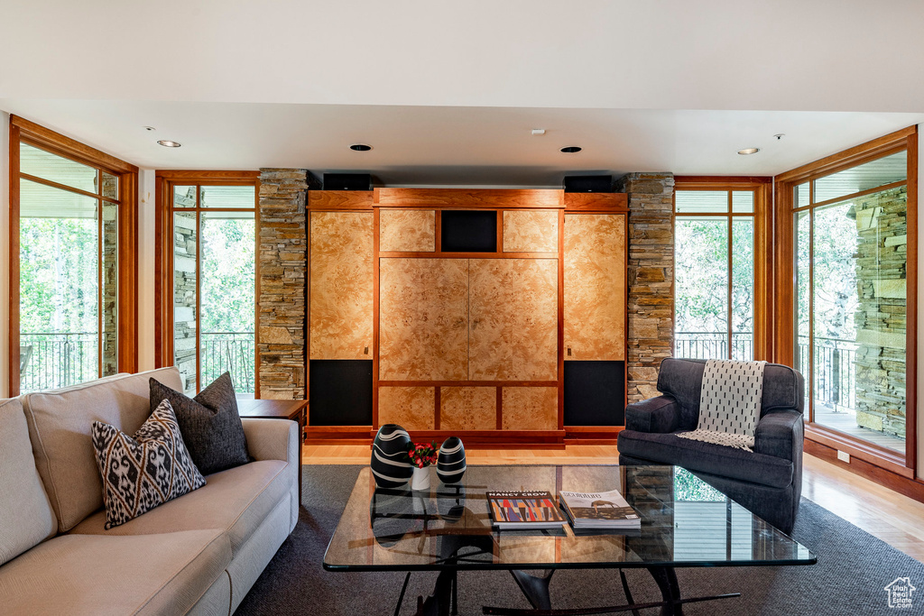 Living area with light wood-type flooring and recessed lighting