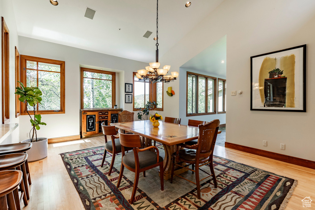 Dining room with recessed lighting, light wood finished floors, visible vents, and an inviting chandelier