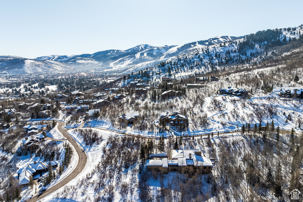 Snowy aerial view featuring a mountain view