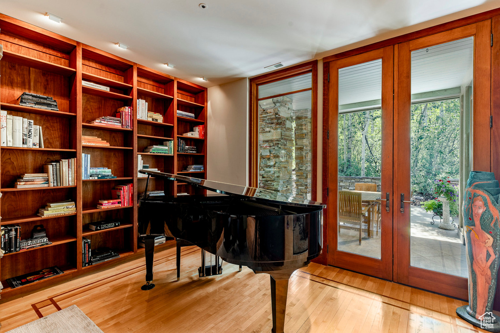 Sitting room featuring visible vents, french doors, and wood finished floors