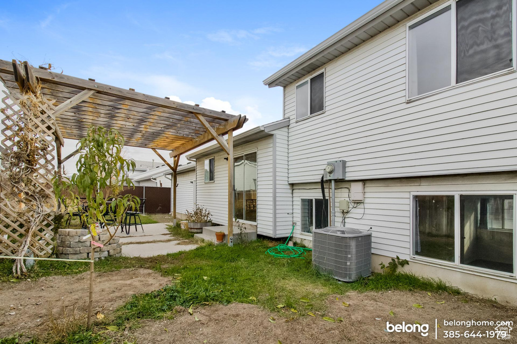 Exterior space featuring a pergola, central AC unit, and a patio