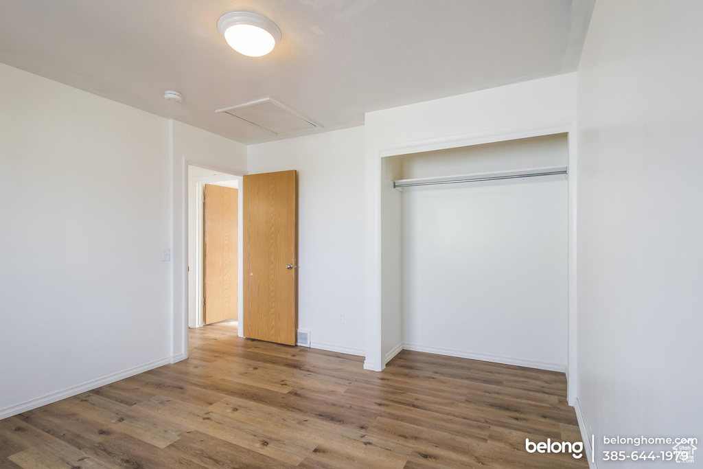 Unfurnished bedroom featuring a closet and wood-type flooring