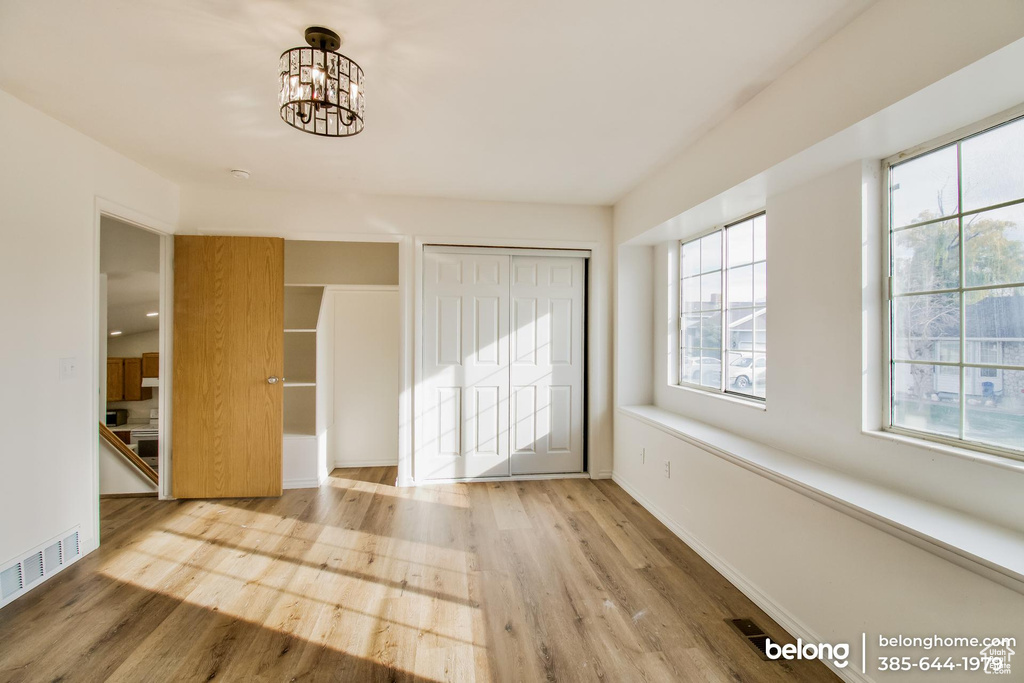 Foyer entrance featuring a chandelier and light hardwood / wood-style floors