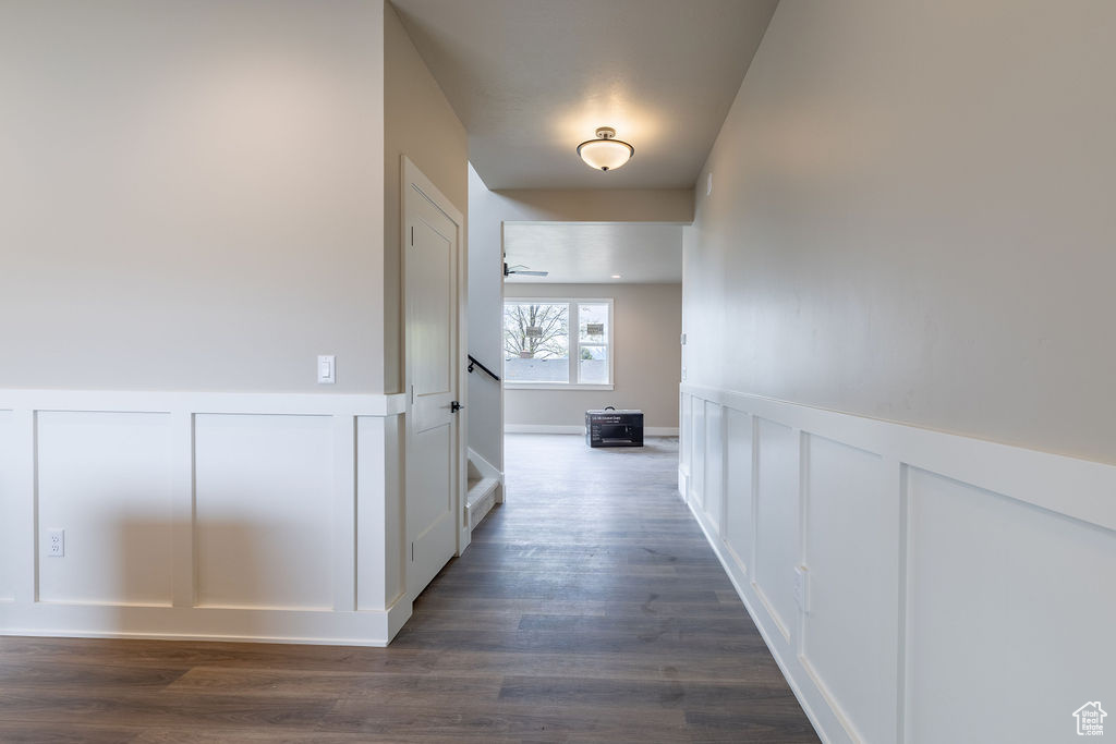 Hallway with dark hardwood / wood-style flooring