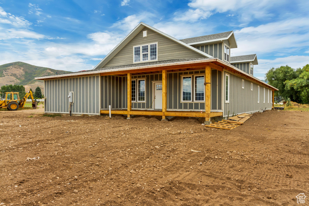 View of front of property with a mountain view and covered porch